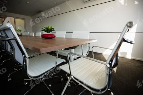 Preview: Empty chairs by conference table at office
