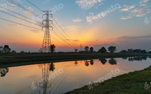 Preview: The silhouette of a high-voltage electric pole in the countryside