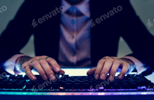 Preview: Hands with tattoo typing on a keyboard