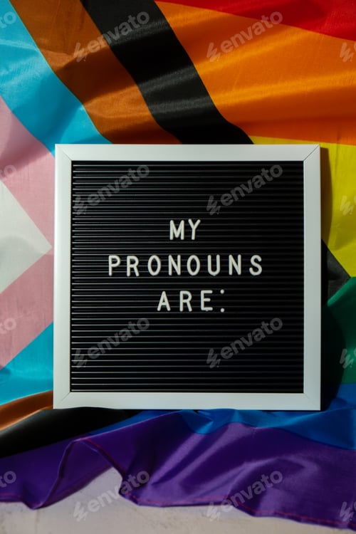 Preview: MY PRONOUNS ARE text Neo pronouns concept on Rainbow flag background gender pronouns. Non-binary