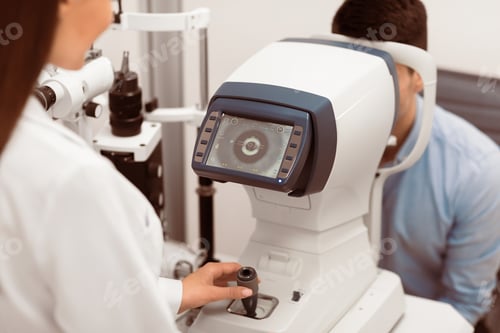 Preview: Optometrist checking patients vision at modern clinic