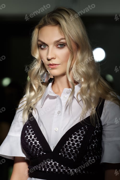 Preview: Pretty lady with clean and healthy skin posing in darkness with lights on background
