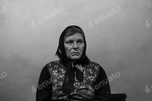 Preview: portrait of 60s russian grandmother senior old woman seating indoors. Old women shawl. Sad person.