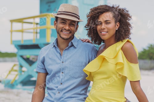 Preview: Cheerful ethnic couple looking at camera