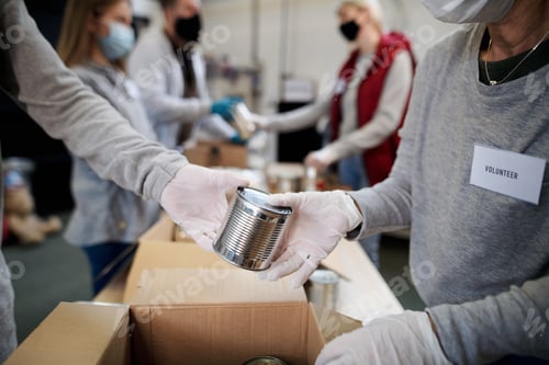 Preview: Group of volunteers in community donation center, food bank and coronavirus concept.