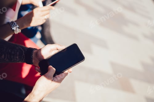 Preview: Anonymous man using empty screen smartphone at city street