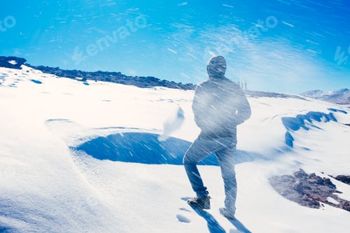 Preview: Man climbing snow mountain with blizzard