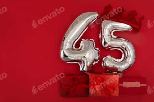 Preview: Balloon 45 in crown on dark red background flat lay