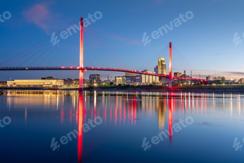 Preview: Omaha, Nebraska, USA downtown city skyline and pedestrian bridge at night.