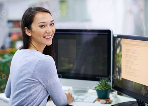 Preview: Shot of an attractive young woman sitting at her workstation in the office