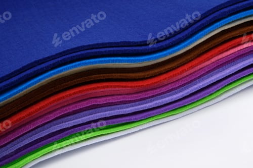Preview: Colorful multi-colored felt on a white background. Soft fabric samples. Wave. Close-up.