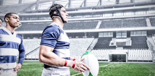 Preview: Digital composite image of two rugby players holding ball in sports stadium