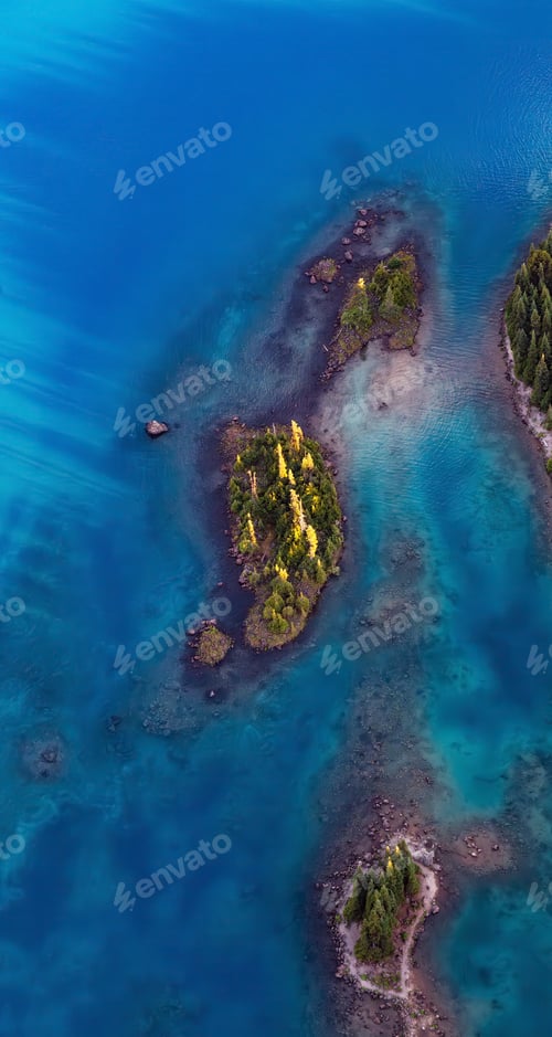 Preview: Aerial View of Rocky Islands and Green Trees on Glacier Lake.