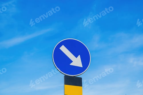 Preview: Mandatory carriageway keep right traffic sign in front of the roundabout