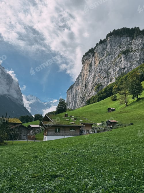 Preview: Traditional chalets dotting a lush green mountain valley