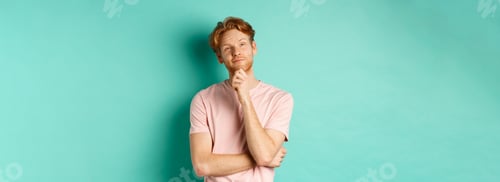Preview: Pensive handsome man with red hair and beard looking at upper left corner, making choice and