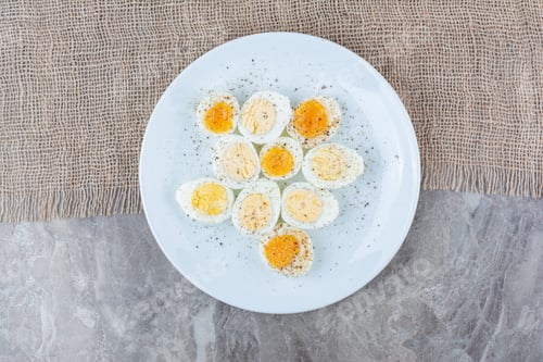 Preview: Boiled tasty eggs with spices on white plate