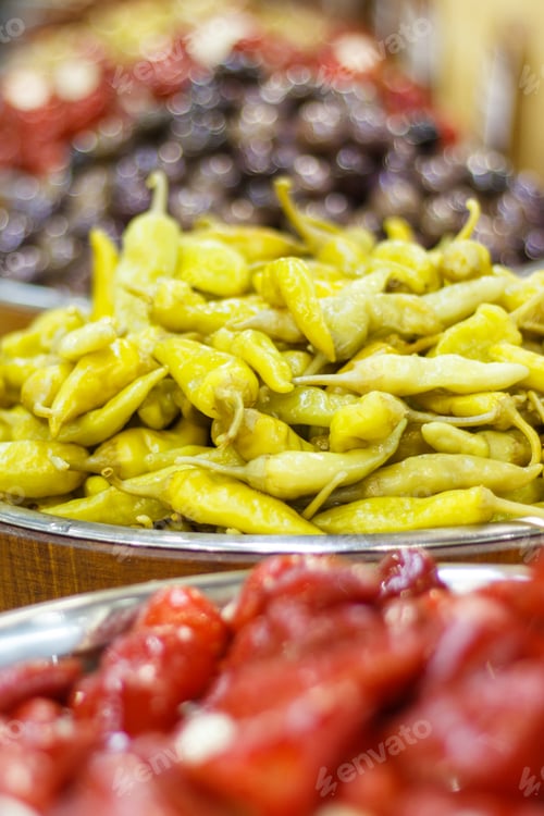 Preview: Fresh natural green marinated peppers in barrels on stall at bazaar