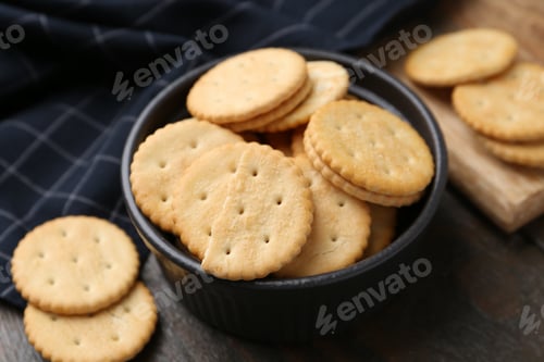 Preview: Tasty salty crackers on wooden table, closeup