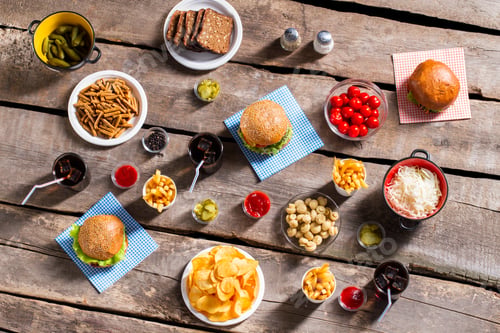 Preview: Burgers and fries with vegetables.