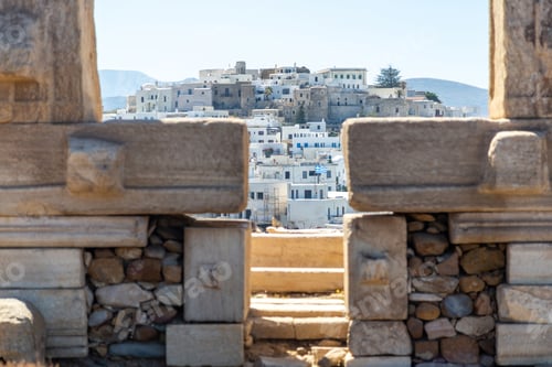 Preview: Naxos island, Greece. Chora buildings view through Portara, the marble gate of Apollo Temple