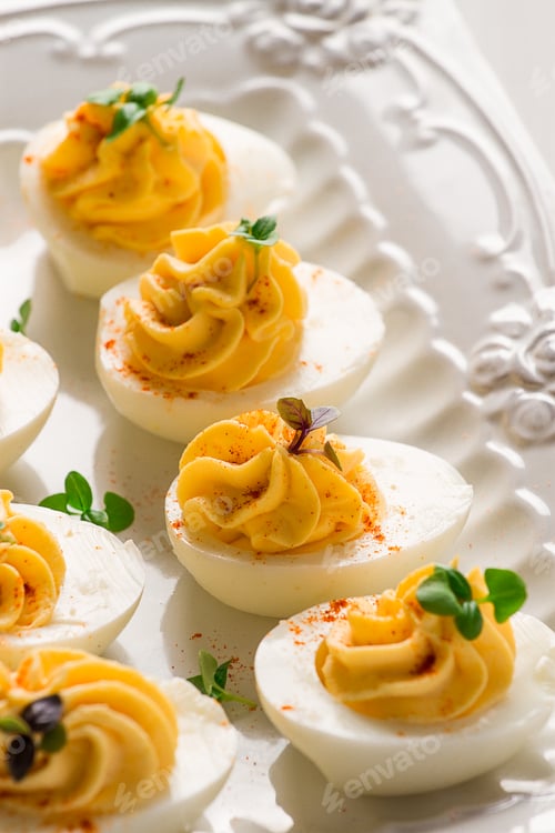 Preview: Boiled eggs stuffed with yolk with mayonnaise, on a white plate, selective focus, blurry,