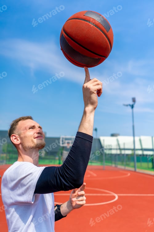Preview: Close-up of guy basketball player spinning a basketball on his finger showing his freestyle skills
