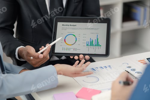 Preview: Group businessmen are reviewing monthly sales documents for analysis and marketing plans for more sa