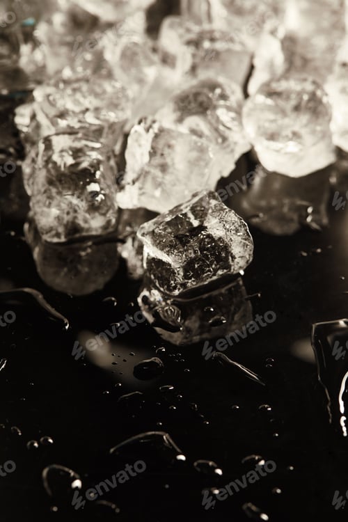 Preview: stack of transparent cool ice cubes on black background with drops