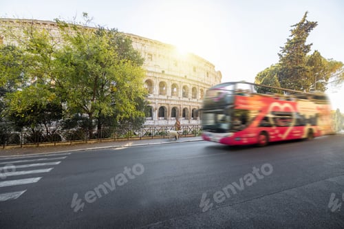 Preview: Street view with motion blurred tourist bus and Colosseum in Rome
