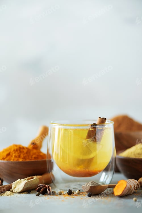 Preview: Ingredients for turmeric hot tea on grey background. Healthy ayurvedic drink with lemon, ginger