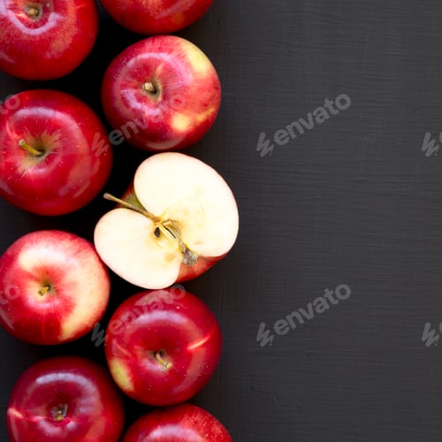 Preview: Overhead view, fresh raw red apples on a black background. Flat lay, top view, from above.