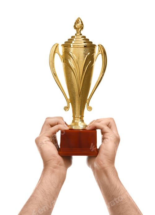 Preview: Young man holding gold trophy cup on white background, closeup