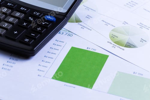 Preview: Graphs and calculator on a table for budget planning and financial management in an office
