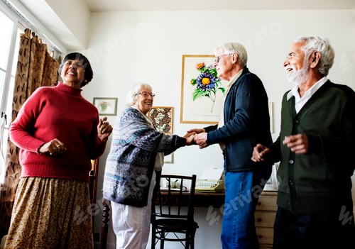 Preview: Senior friends dancing together at home