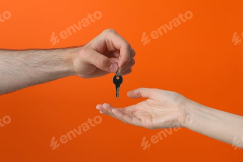 Preview: Female and male hand with a key