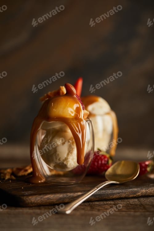 Preview: delicious ice cream with caramel in glass on chopping board