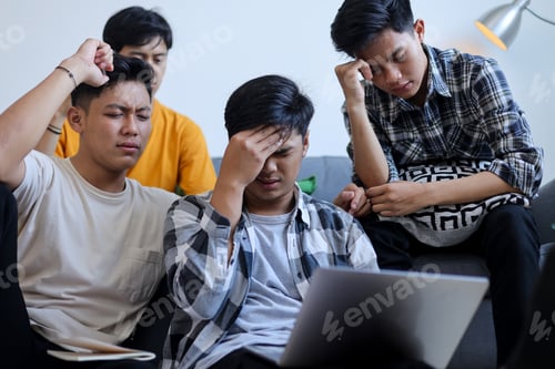 Preview: Group of Young Asian Men Looking Stressed and Frustrated While Working on Laptop