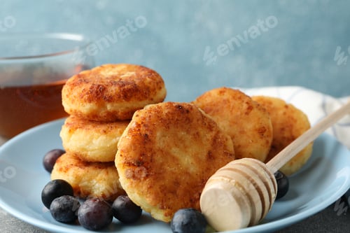 Preview: Breakfast of cheese pancakes against blue background, close up