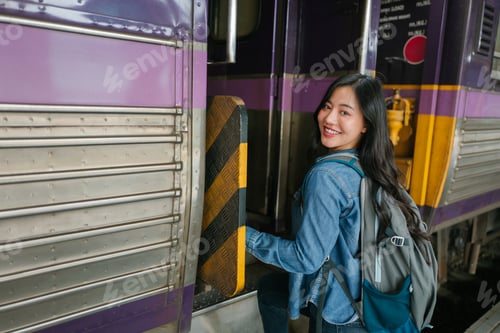Preview: Happy female backpacker boarding train, starting travel adventure