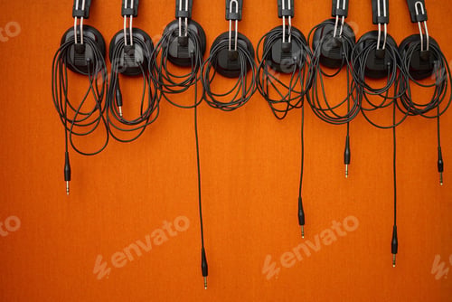Preview: Audio, music and headphones hanging on a wall for a dj, podcast or radio production in the studio.