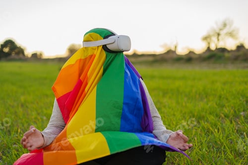 Preview: LGBT person meditating in VR headset in nature