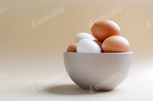 Preview: Different farm eggs in a bowl on a pastel background. Healthy food concept, organic food