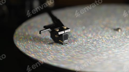 Preview: Retro-styled spinning silver record vinyl player. Close up glitter surface. phonograph