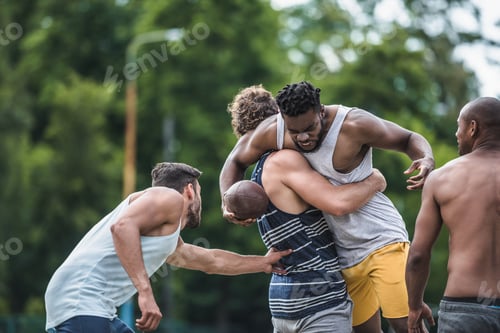 Preview: group of young multicultural men playing football on court