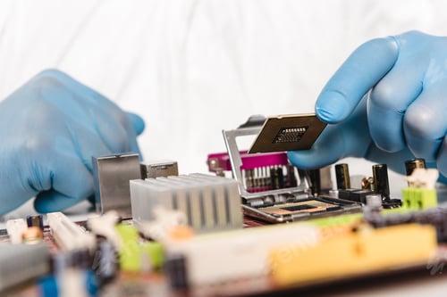 Preview: cropped view of microchip in hands of scientist in latex gloves