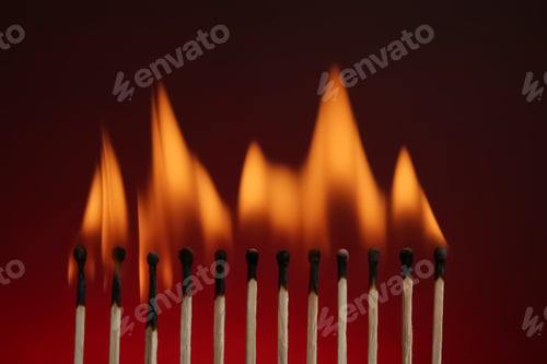 Preview: Line of burning matches on color background
