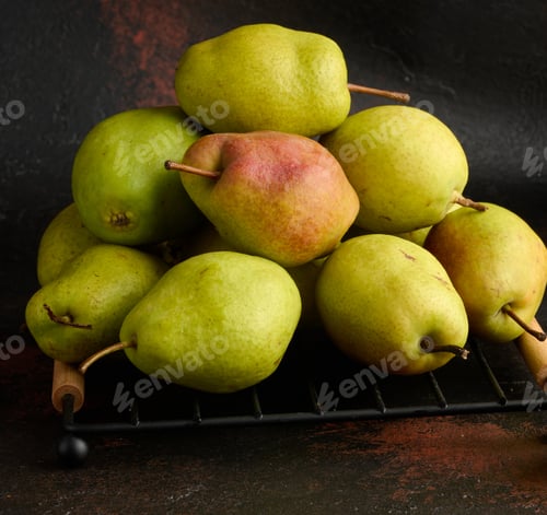 Preview: A pile of green pears on a brown background