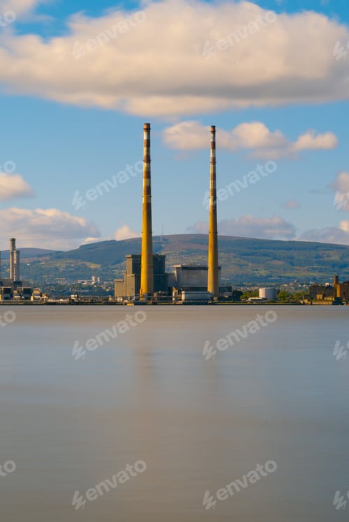 Preview: Beautiful view of a lake near a factory in a city under a cloudy sky
