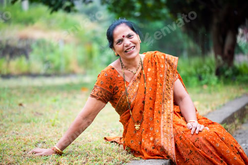 Preview: Happy Indian woman in traditional clothes at outdoor.